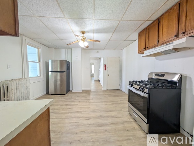 A room with wooden floors and a ceiling fan.