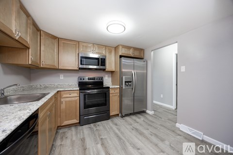 A kitchen with wooden cabinets and a black oven.