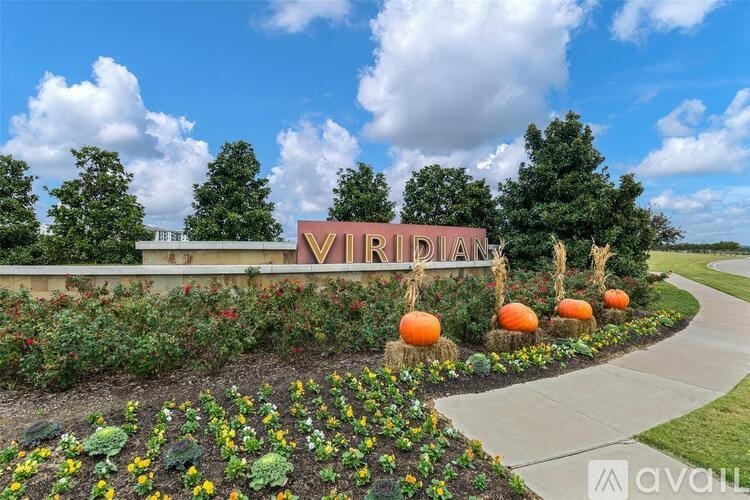 A sign that says "VIRGINIA" is surrounded by flowers and pumpkins.