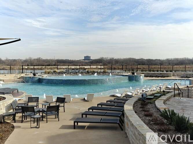 A pool with a waterfall and a water slide.