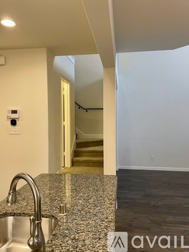 A kitchen with granite countertops and a stainless steel sink.