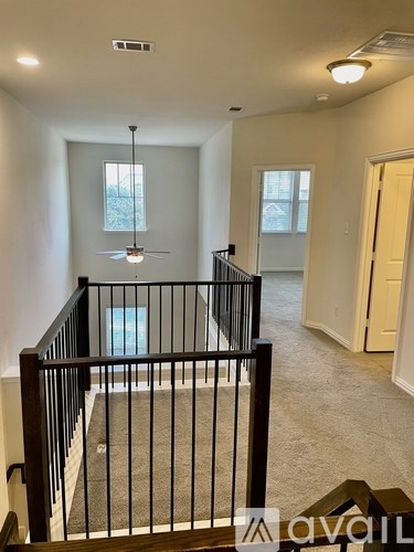 A living room with a staircase leading to the upper floor.
