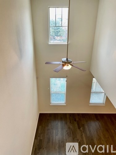 A room with a ceiling fan and a window.