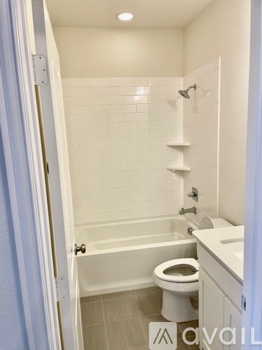 A bathroom with a toilet, sink, and bathtub.