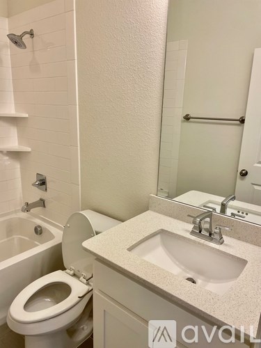 A white toilet is next to a sink in a bathroom.