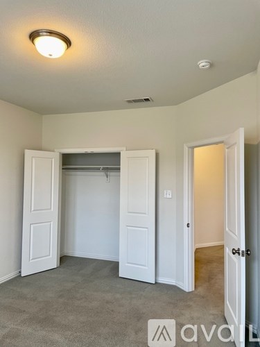 A room with a carpeted floor and white walls.