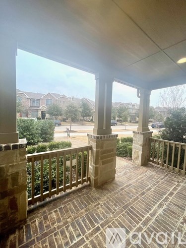 A balcony with a view of a residential area.
