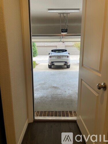A car is parked in a driveway outside a house.