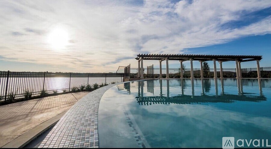 A sunny day at the pool with a sunset in the background.