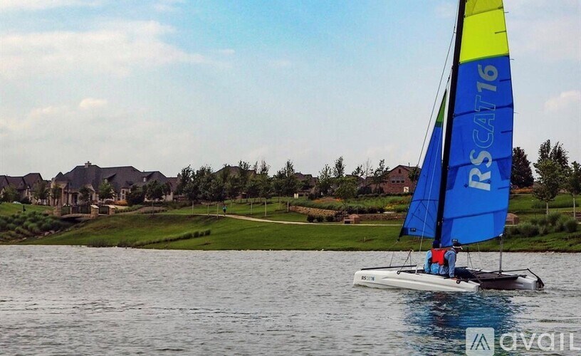 A sailboat with the number 76 on its sail is sailing on the water.