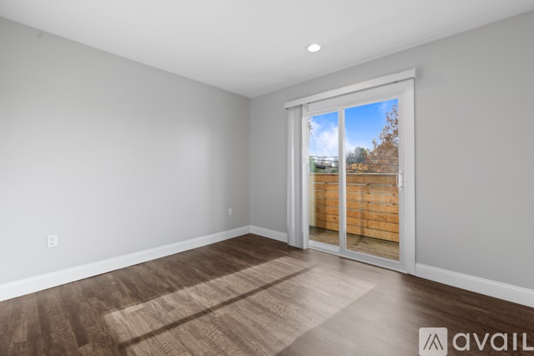 A room with a sliding glass door leading to a wooden fence.