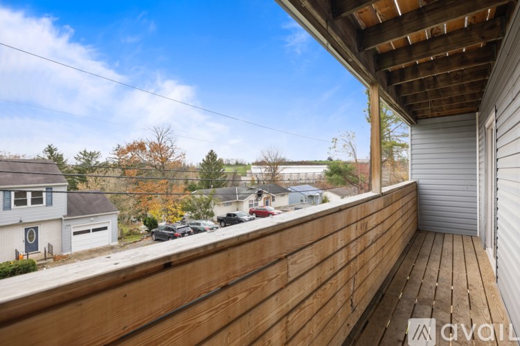 A wooden deck with a view of a residential area.