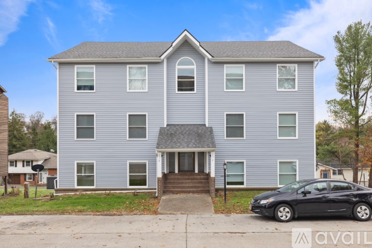 A house with a car parked in front of it.