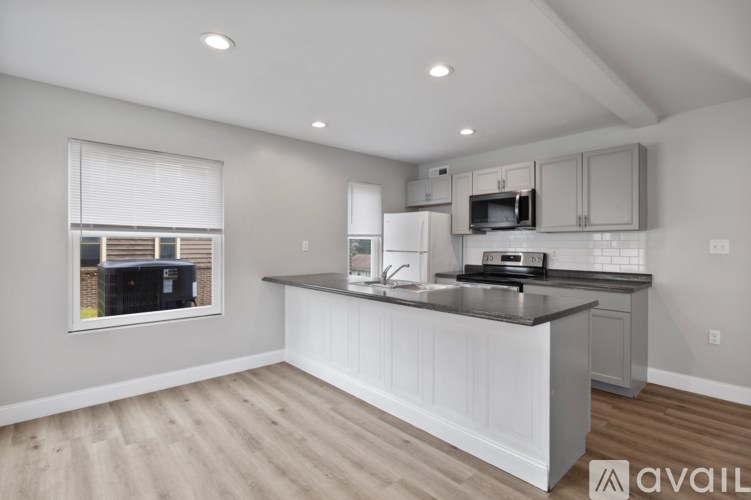 A kitchen with a large island and a window.