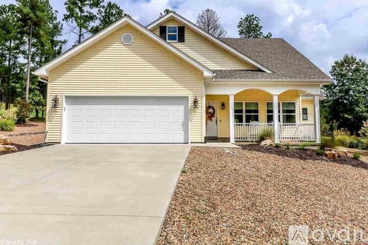A two-car garage is attached to a house with a white door and windows.