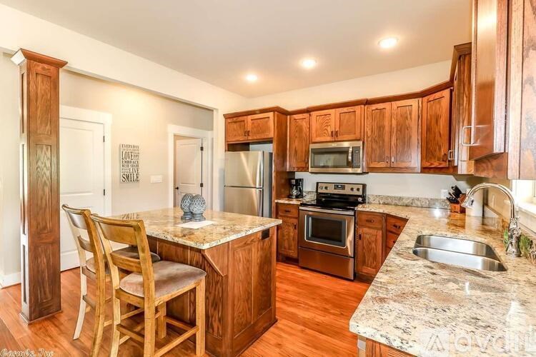 A kitchen with wooden cabinets and a granite countertop.