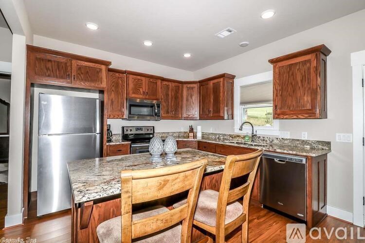 A kitchen with wooden cabinets and a granite countertop.