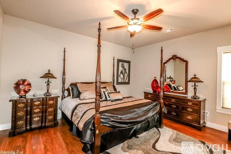 A bedroom with a four poster bed and a dresser.