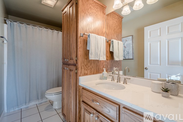A bathroom with a toilet, sink, and shower.
