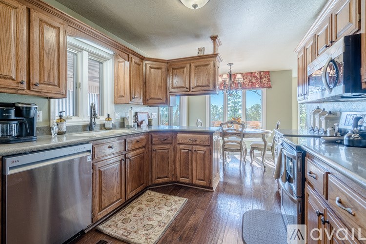 A kitchen with wooden cabinets and a rug on the floor.