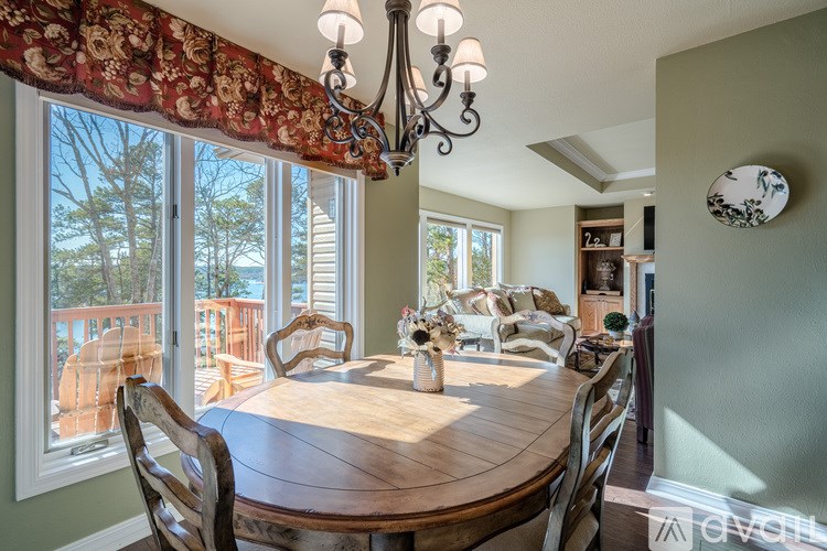A dining room with a wooden table and chairs.