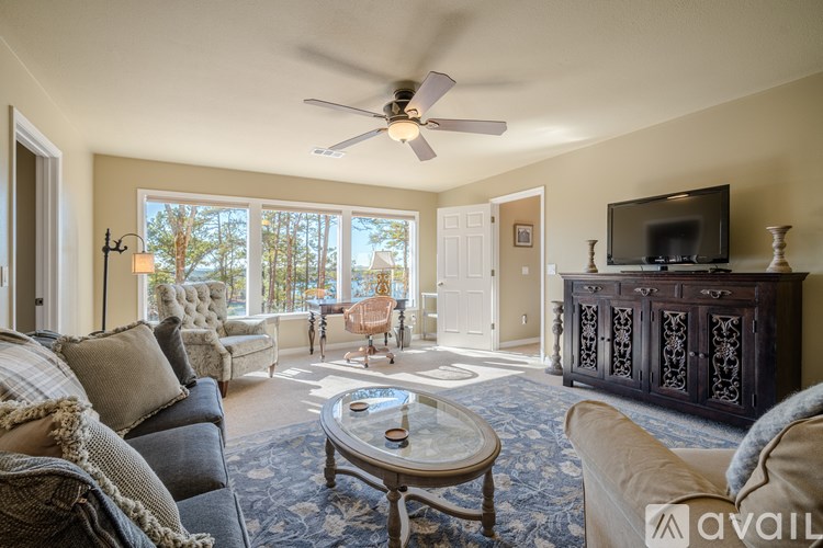 A living room with a couch, a coffee table, and a television.