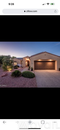 A house with a driveway and a garage is shown.