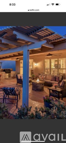 A patio with a table and chairs is set up outside a house.