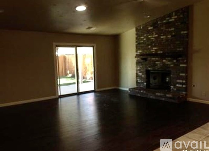 A living room with a fireplace and sliding glass doors.