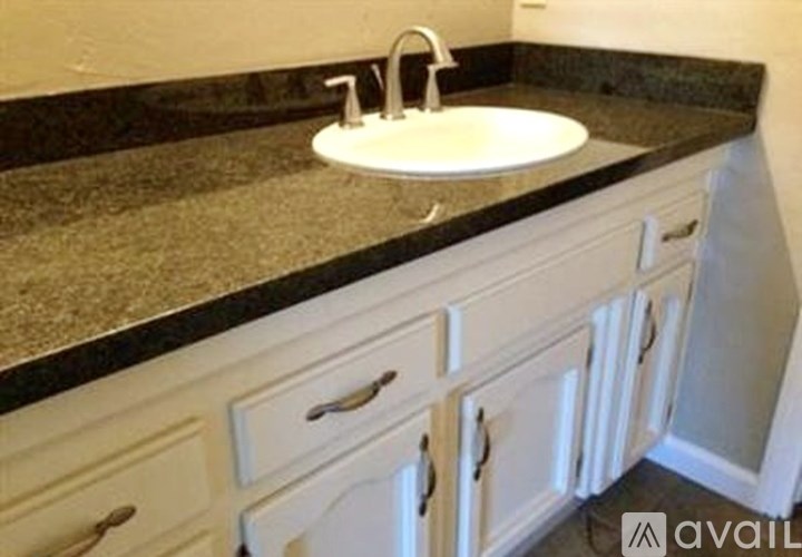 A bathroom with a sink and cabinets.