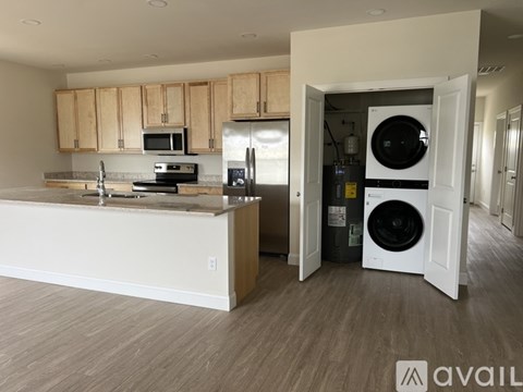 A modern kitchen with wooden cabinets and a white countertop.