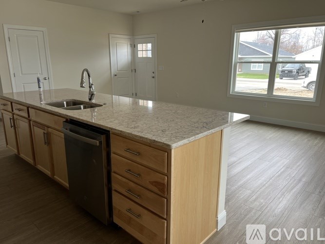 A kitchen with wooden cabinets and a granite countertop.