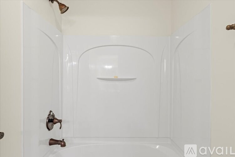 A white bathroom with a shower and a glass door.