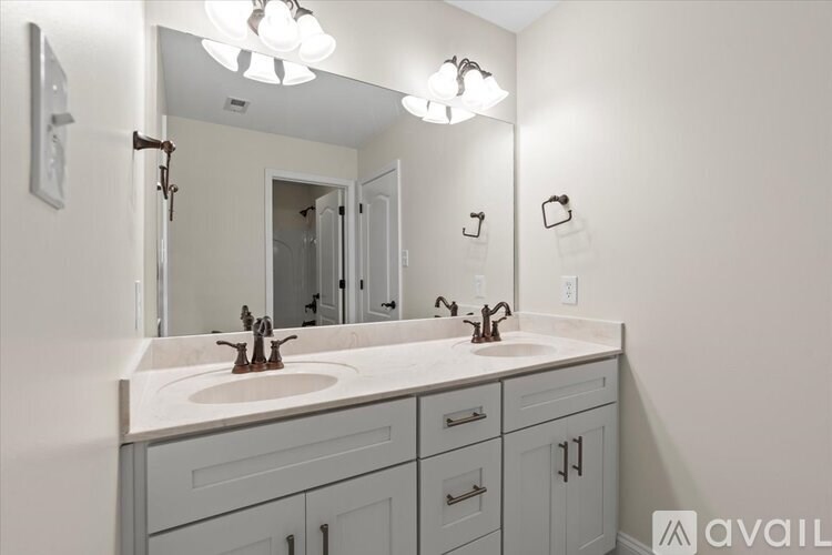 A bathroom with a double sink vanity and a large mirror.