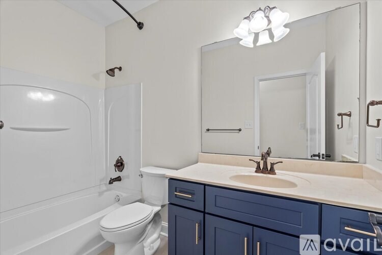 A bathroom with a white toilet, a sink, and a mirror.