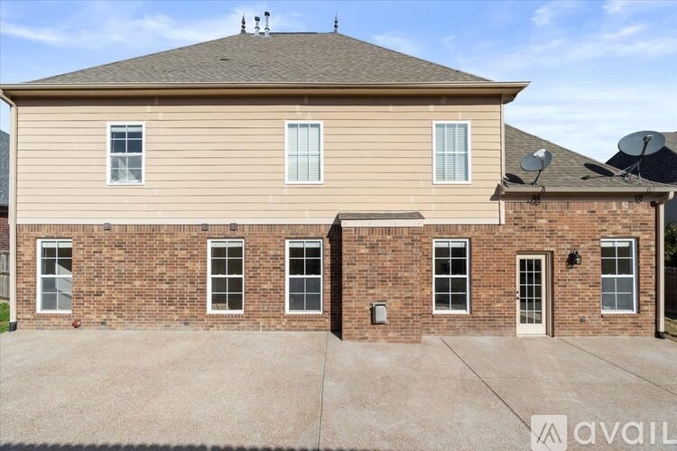 A two-story house with a garage and a driveway.
