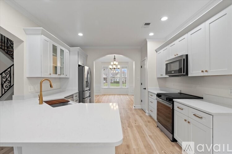 A modern kitchen with white cabinets and a large island.