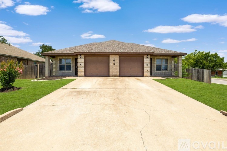 A house with a driveway in front of it is for sale.