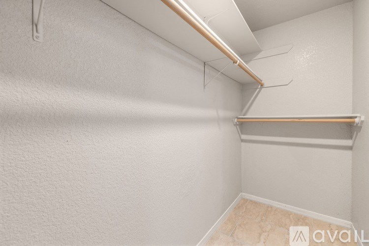 A white wall with a shelf and a pipe.