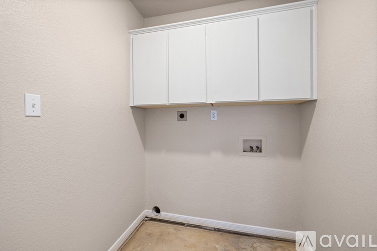 A wall with a white cabinet and two switches.