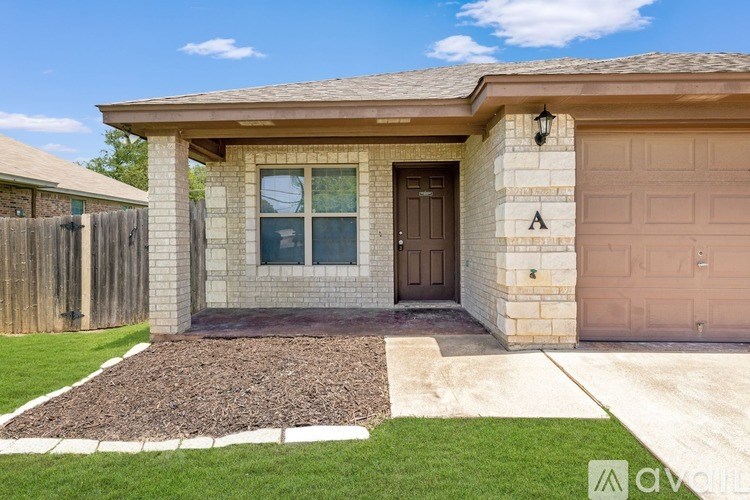 A house with a brown door and a brown garage door.