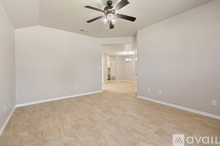 A spacious room with a ceiling fan and light fixture.
