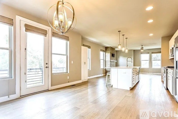 A spacious kitchen with a white island in the middle.