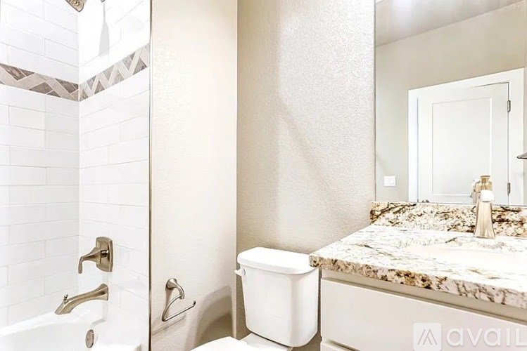 A bathroom with a marble countertop and a white toilet.