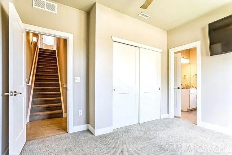 A living room with a staircase leading to the upper floor.