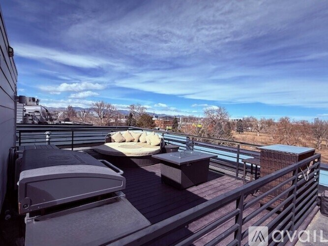A balcony with a table and chairs overlooking a snowy landscape.