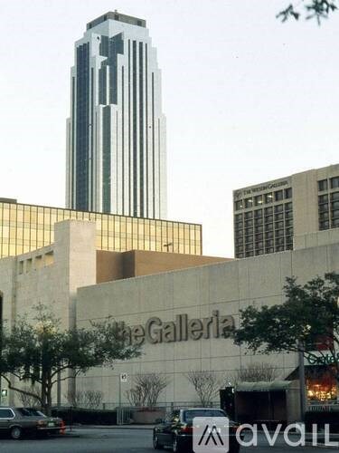 The Galleria is a large building with a tall skyscraper in the background.