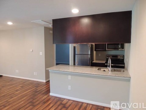 A kitchen with a sink and a microwave.