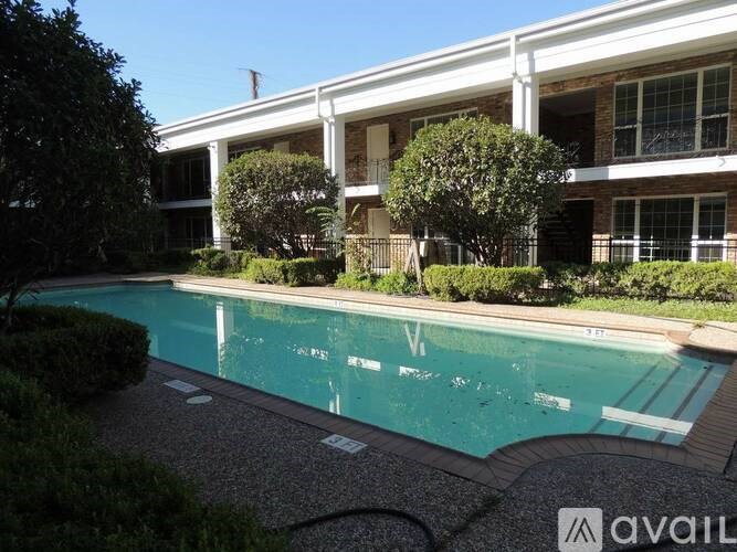 A swimming pool in front of a building with a sign that says "AVAIL".