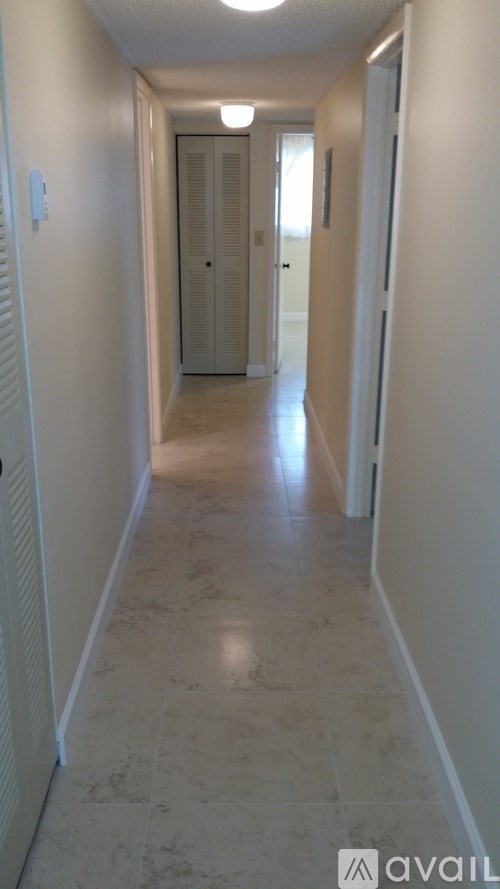 A long hallway with a door at the end.